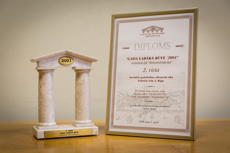 AS “Būvuzņēmums Restaurators” received recognition in the competition “Best Building 2001 [in Latvia]” in the category “Reconstruction” (2nd place) on 5 April 2002. This award was granted for reconstruction works carried out in 2001 in the Social Services building in Riga, 3 Vidrizu Street.