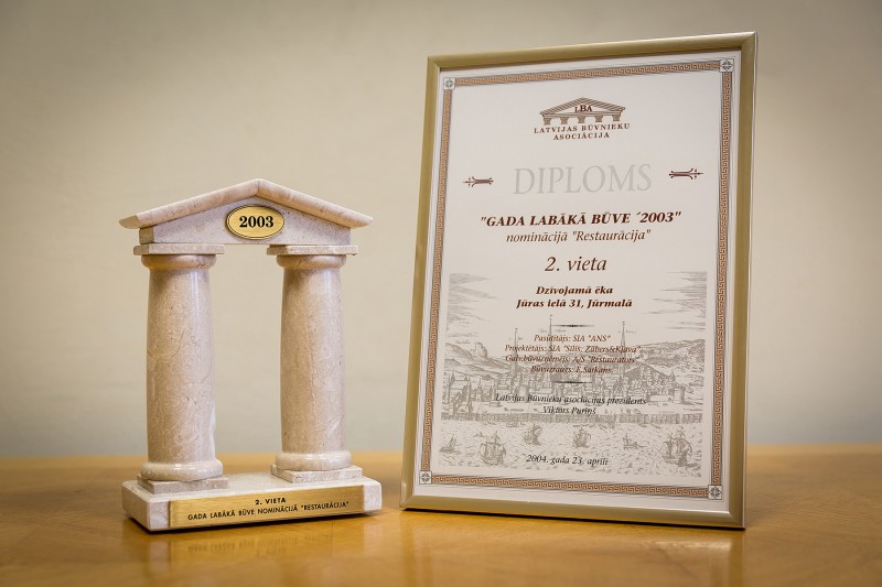 AS “Būvuzņēmums Restaurators” received recognition in the competition “Best Building 2003 [in Latvia]” in the category “Restoration” (2nd place) on 23 April 2004. This award was granted for restoration of a residential building in Jurmala, 31 Juras Street, carried out in 2003.